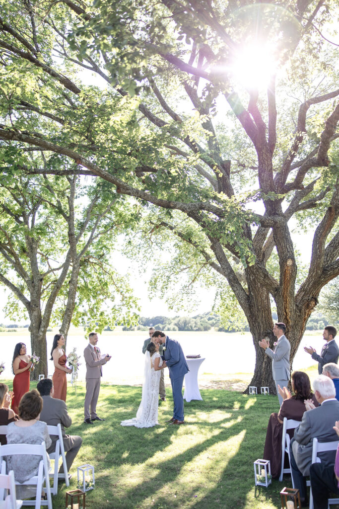 The Vincent Homestead wedding venue in Temple, Texas featuring a lakeside ceremony space surrounded by rolling hills and mature trees