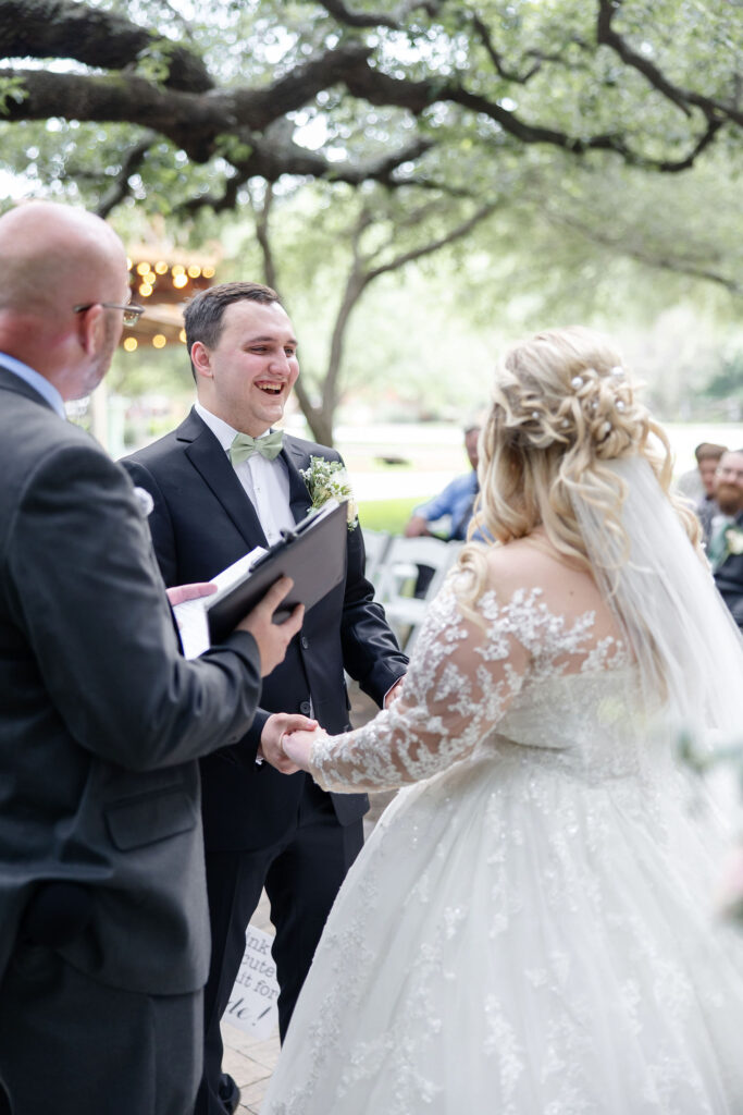 Bride and groom celebrating at Trickle Creek Ranch, a scenic wedding venue near Fort Worth surrounded by oak trees, lush landscaping, and peaceful countryside.