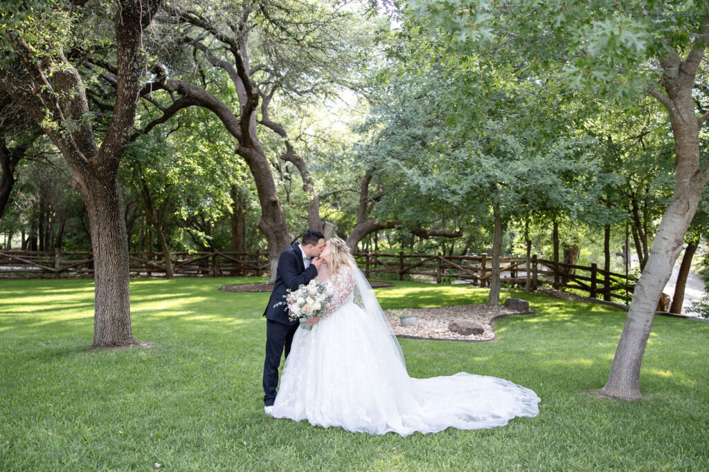 Scenic wedding portraits at Trickle Creek Ranch showcasing the property's spring-fed creek, towering oak trees, and beautiful Texas landscape.