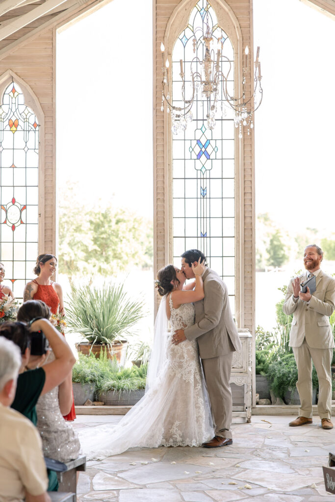 Bride and groom celebrating at Gruene Estate, a historic wedding venue in Gruene, New Braunfels, Texas with beautiful Hill Country scenery.