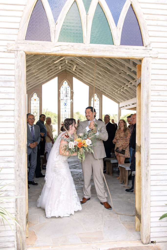 Bride and groom celebrating at Gruene Estate, a historic wedding venue in Gruene, New Braunfels, Texas with beautiful Hill Country scenery.