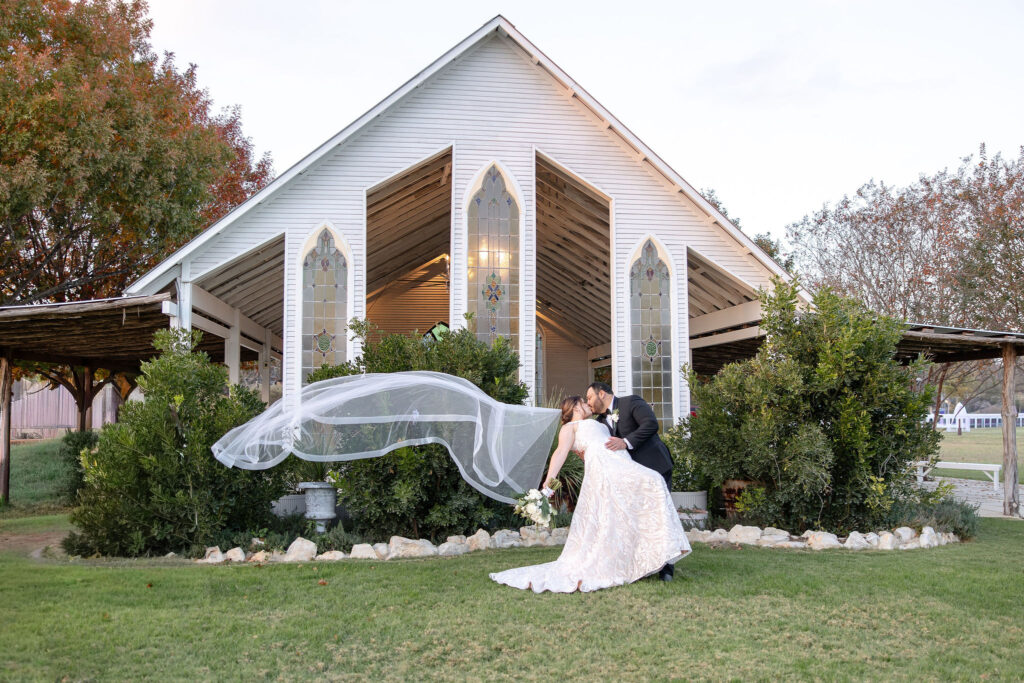 Outdoor wedding ceremony at Gruene Estate in Gruene, Texas showcasing the original open-air chapel and peaceful countryside setting.